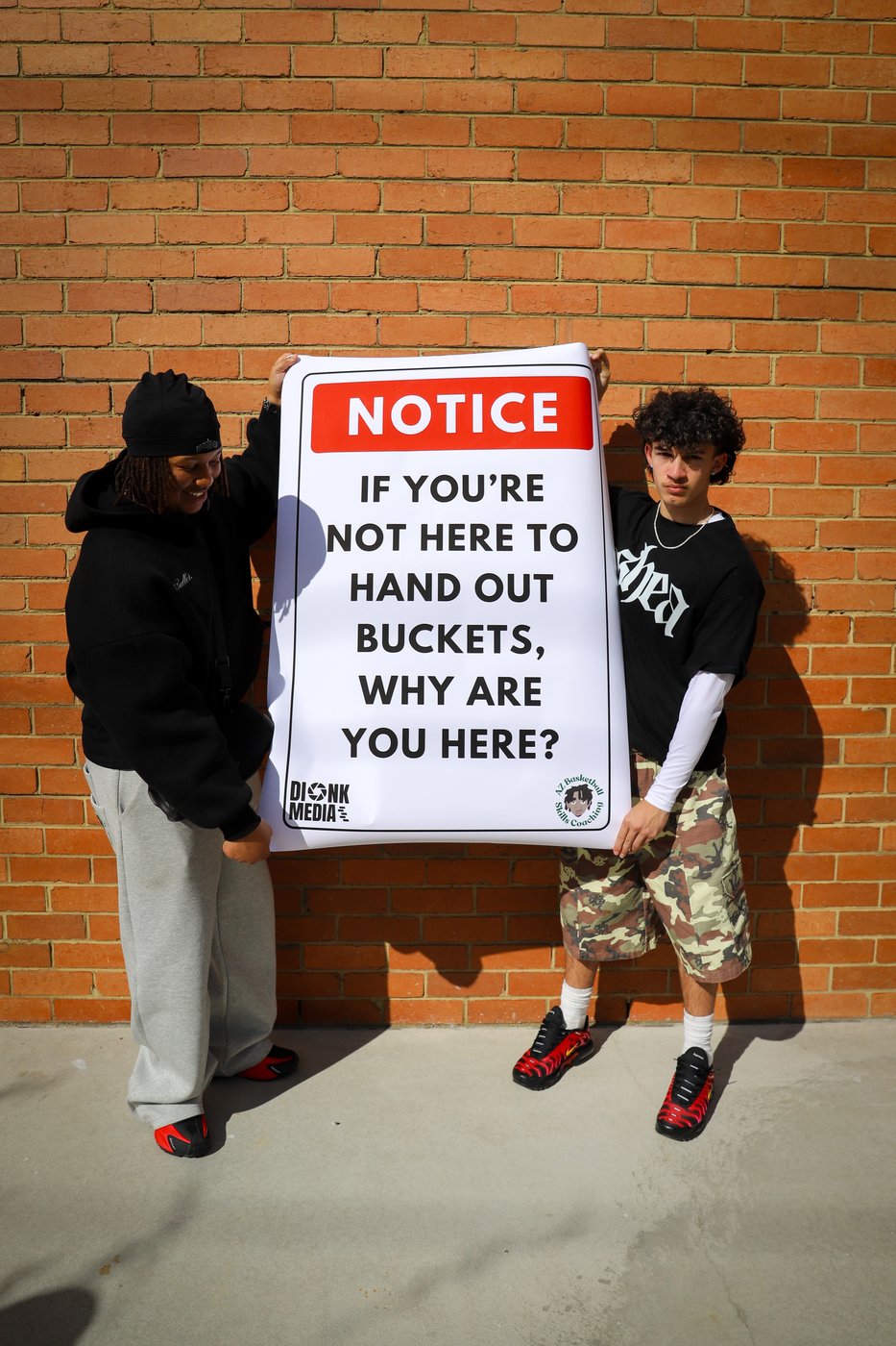 Players holding the A2Z 'hand out buckets' notice sign
