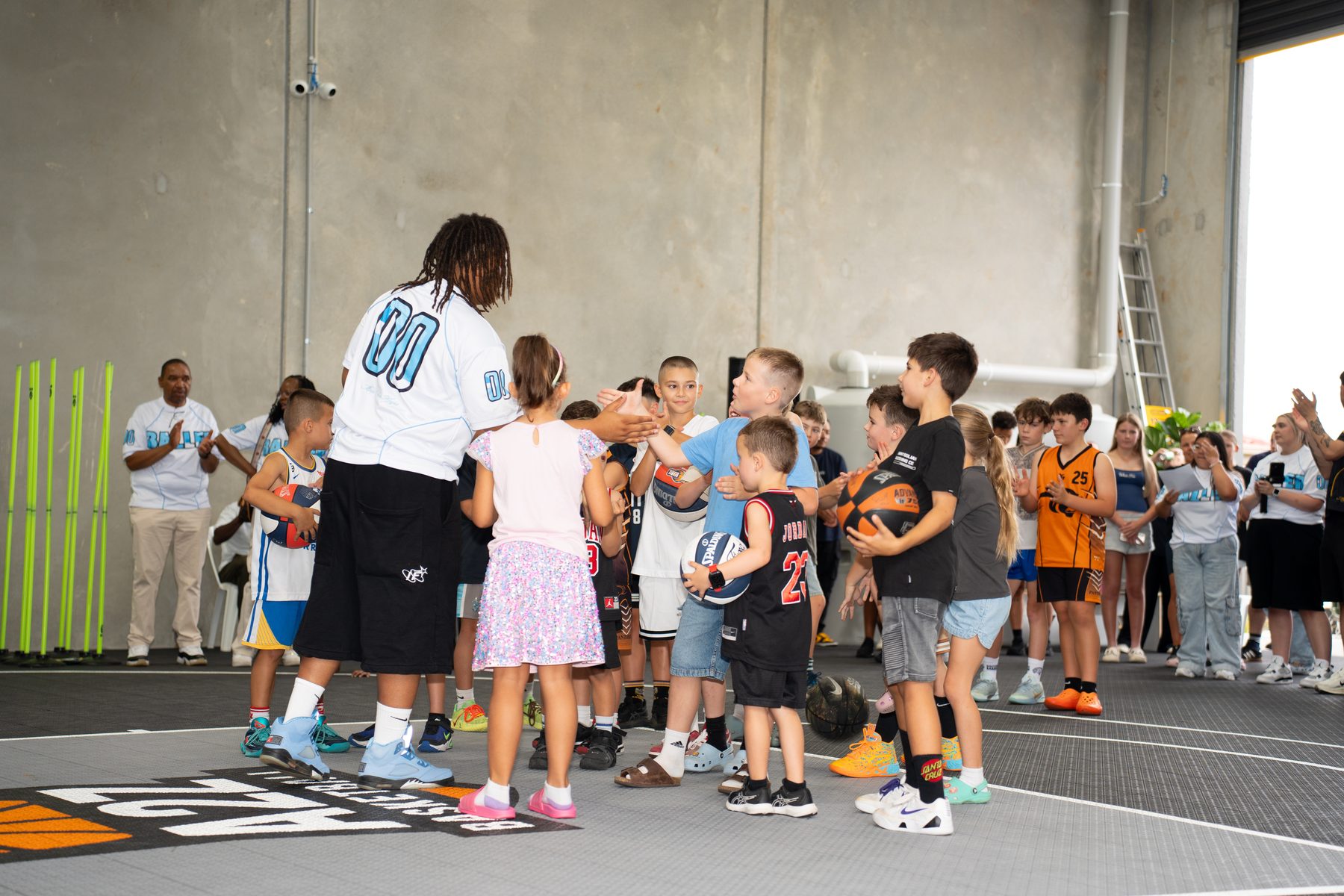 Kids high-fiving players at the A2Z grand opening